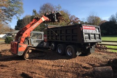 Loading brush onto dump truck
